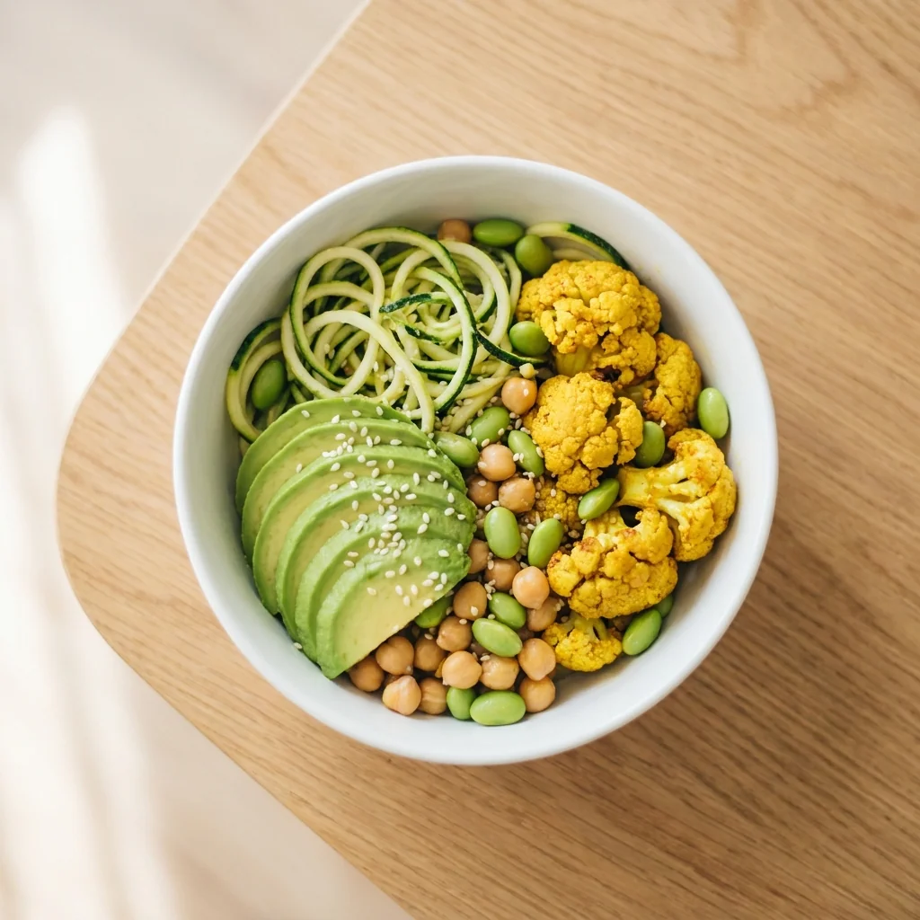 Grüne Greta Bowl mit Avocado, Zucchininudeln, Kurkumablumenkohl, Edamame, Kichererbsen und Sesam